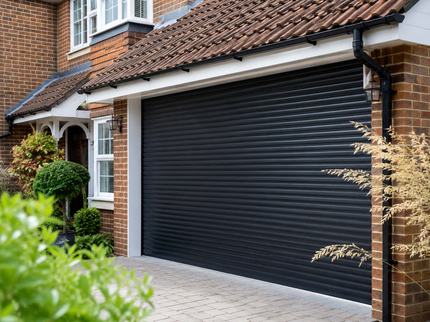 Residential rolling shutter installed at commercial entrance — front elevation view
